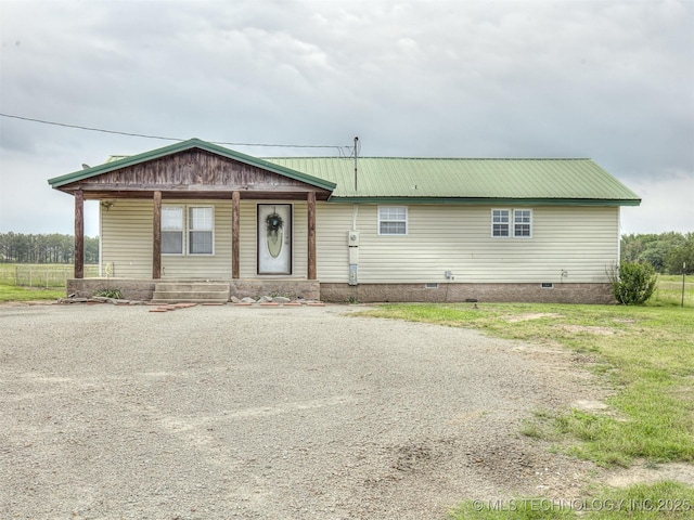32550 S 250th Rd, Henryetta, OK 74437 - view of front of house featuring a porch, crawl space, metal roof, and gravel driveway