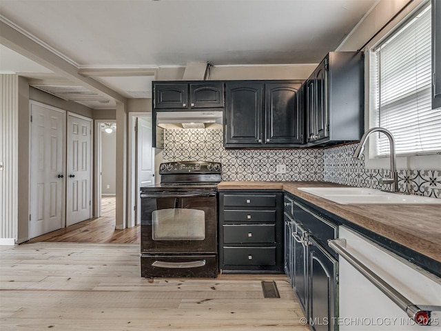 32550 S 250th Rd, Henryetta, OK 74437 - kitchen with black electric range oven, a sink, white dishwasher, under cabinet range hood, and light wood-type flooring