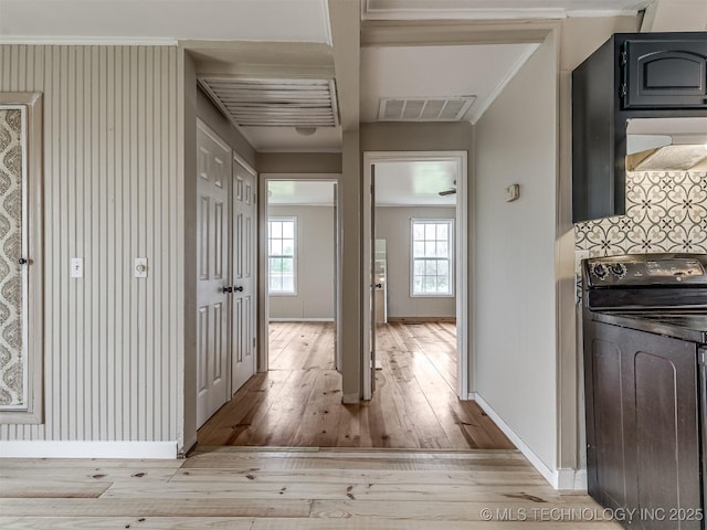 32550 S 250th Rd, Henryetta, OK 74437 - hall featuring washer / dryer, light wood-type flooring, baseboards, and crown molding