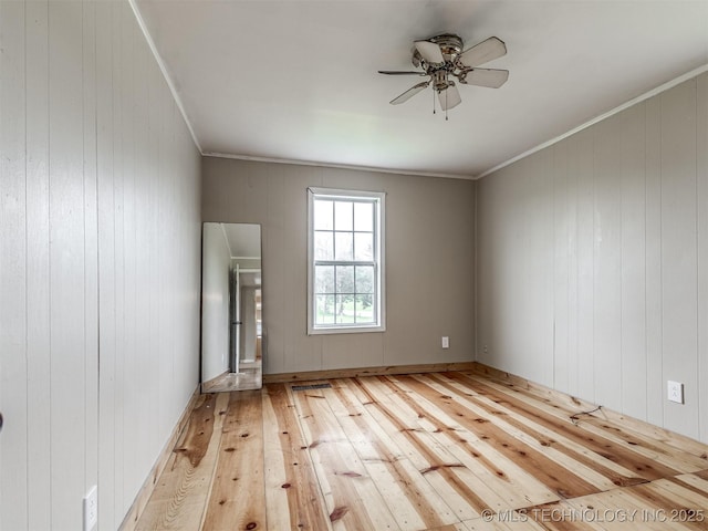 32550 S 250th Rd, Henryetta, OK 74437 - unfurnished living room with wood-type flooring, a ceiling fan, wooden walls, and crown molding