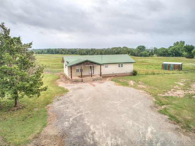 32550 S 250th Rd, Henryetta, OK 74437 - view of front of property featuring covered porch, driveway, metal roof, and a view of rural / pastoral area