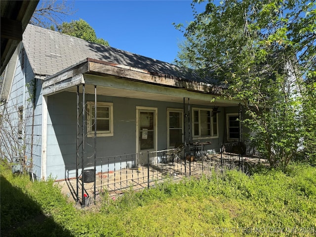900 S Mabel Ave, Wagoner, OK 74467 - back of house with a patio area and roof with shingles