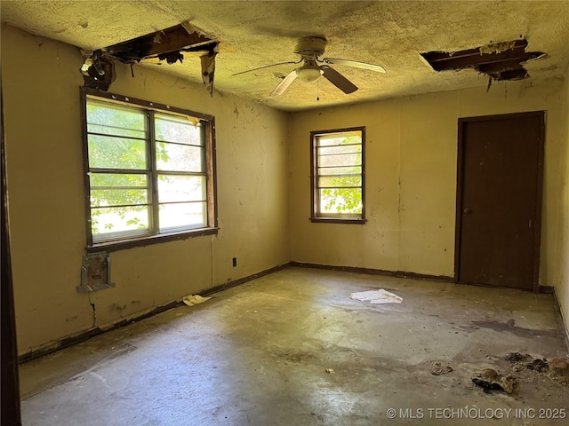 900 S Mabel Ave, Wagoner, OK 74467 - spare room with ceiling fan and concrete floors