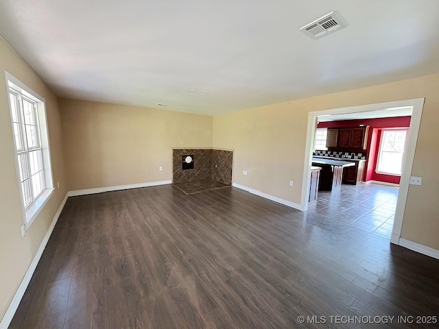 21253 S 530th Rd, Tahlequah, OK 74464 - unfurnished living room featuring dark wood-type flooring and baseboards