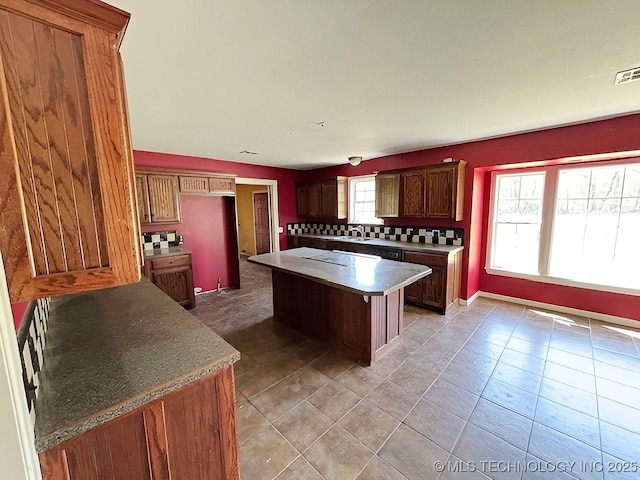21253 S 530th Rd, Tahlequah, OK 74464 - kitchen featuring tasteful backsplash, a kitchen island, a sink, and light tile patterned flooring