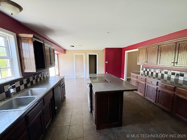 21253 S 530th Rd, Tahlequah, OK 74464 - kitchen featuring a sink, tasteful backsplash, a center island, dark tile patterned flooring, and dark countertops