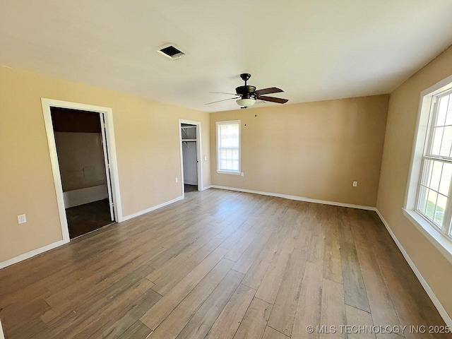 21253 S 530th Rd, Tahlequah, OK 74464 - unfurnished room featuring ceiling fan, wood finished floors, plenty of natural light, and baseboards