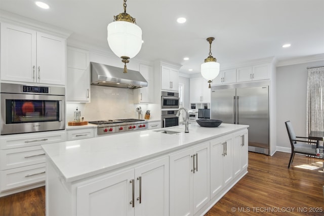 201 E 24th Pl, Tulsa, OK 74114 - kitchen with appliances with stainless steel finishes, a sink, wall chimney range hood, white cabinets, and light countertops