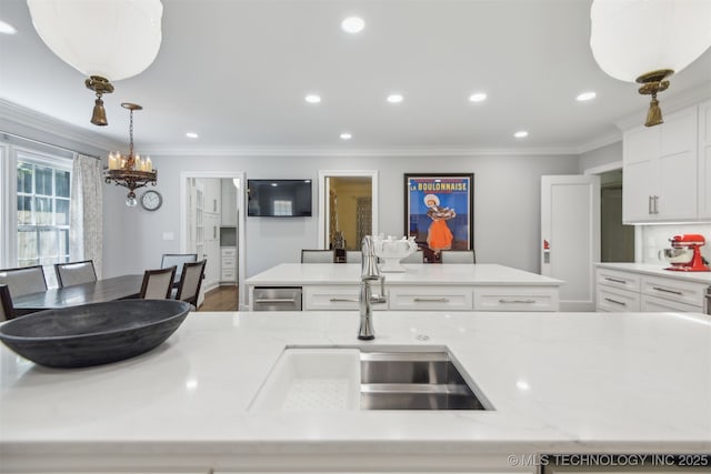 201 E 24th Pl, Tulsa, OK 74114 - kitchen featuring ornamental molding, white cabinetry, a sink, a kitchen island, and recessed lighting