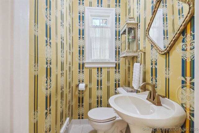 201 E 24th Pl, Tulsa, OK 74114 - half bathroom with toilet, tile patterned flooring, and a sink