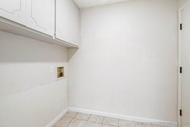 83 Oak St, Durant, OK 74701 - washroom featuring cabinet space, hookup for a washing machine, baseboards, and light tile patterned floors