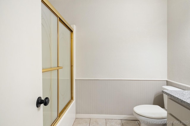 83 Oak St, Durant, OK 74701 - full bath featuring vanity, tile patterned flooring, bath / shower combo with glass door, toilet, and baseboards