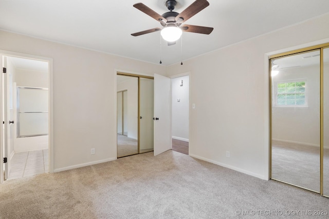 83 Oak St, Durant, OK 74701 - unfurnished bedroom with carpet floors, multiple closets, ensuite bath, baseboards, and ceiling fan