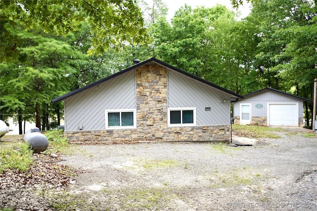 116942 S 4244th Rd, Eufaula, OK 74432 - view of home's exterior featuring stone siding, an outdoor structure, and a garage