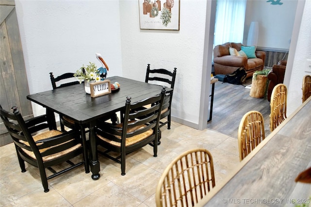116942 S 4244th Rd, Eufaula, OK 74432 - dining space featuring a textured wall, light tile patterned floors, and baseboards