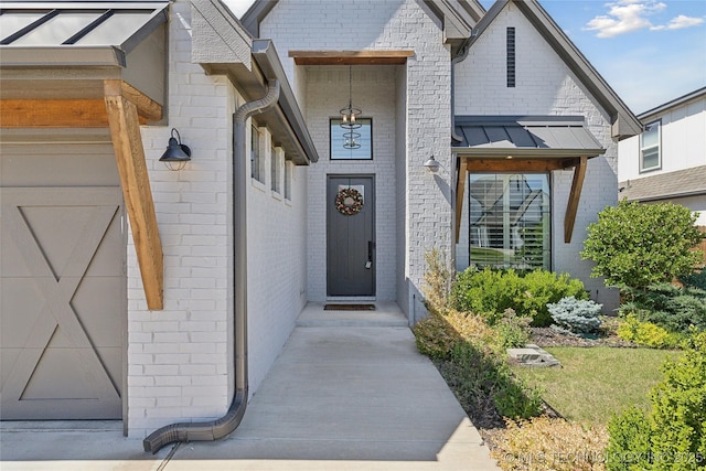 1205 W 88th St S, Tulsa, OK 74132 - view of exterior entry with brick siding and a standing seam roof