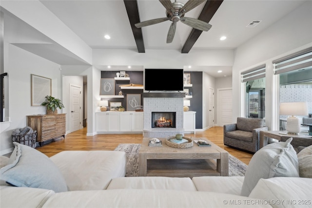 1205 W 88th St S, Tulsa, OK 74132 - living room featuring beam ceiling, ceiling fan, recessed lighting, wood finished floors, and a fireplace