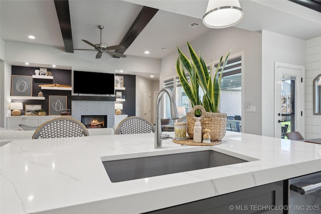 1205 W 88th St S, Tulsa, OK 74132 - kitchen with a sink, open floor plan, a fireplace, ceiling fan, and beam ceiling