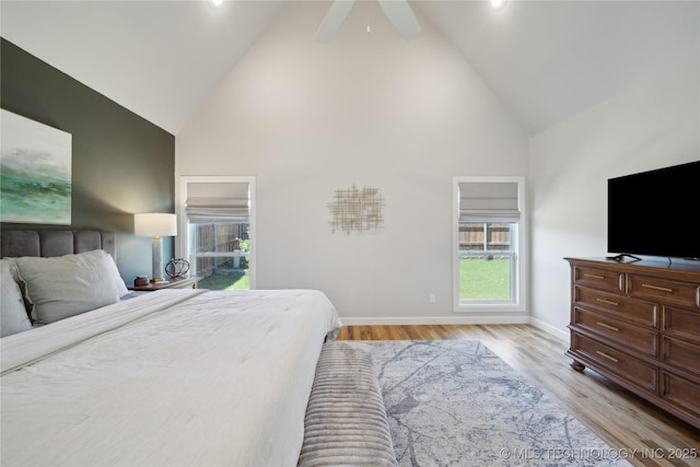 1205 W 88th St S, Tulsa, OK 74132 - bedroom with high vaulted ceiling, baseboards, light wood-type flooring, and a ceiling fan