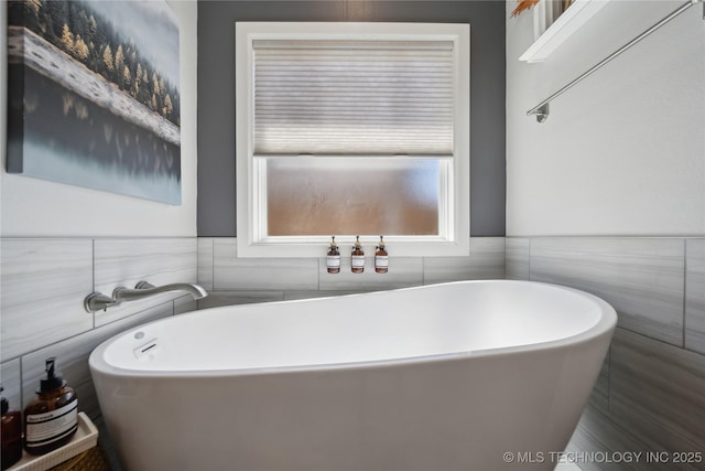 1205 W 88th St S, Tulsa, OK 74132 - full bathroom with a soaking tub, tile walls, and wainscoting