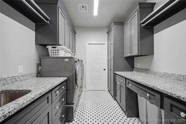 1205 W 88th St S, Tulsa, OK 74132 - laundry area featuring washing machine and clothes dryer, cabinet space, and light floors