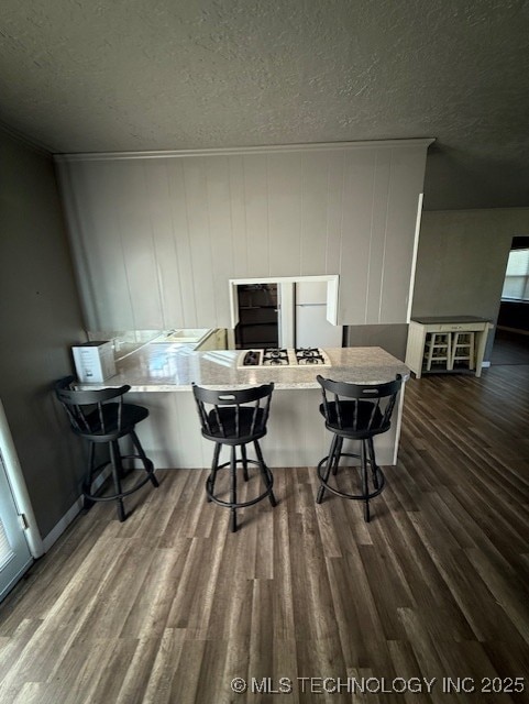 3229 E Cherokee Ave, Sallisaw, OK 74955 - office space featuring a textured ceiling, ornamental molding, and dark wood-type flooring