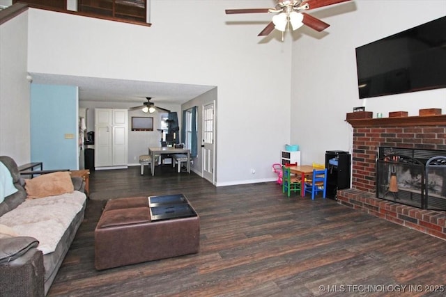 1146 E 137th St, Glenpool, OK 74033 - living area featuring ceiling fan, wood finished floors, a fireplace, baseboards, and a towering ceiling