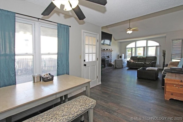 1146 E 137th St, Glenpool, OK 74033 - dining space featuring ceiling fan, dark wood-style flooring, a brick fireplace, and lofted ceiling