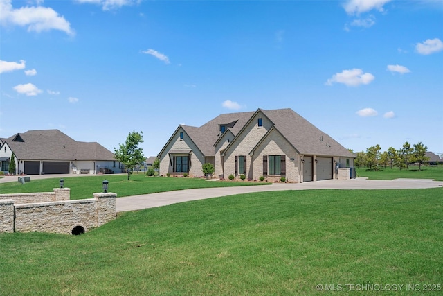 8209 N 150th Ave E, Owasso, OK 74055 - french country style house featuring concrete driveway, a front lawn, brick siding, and roof with shingles
