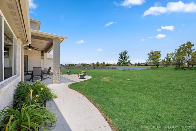 8209 N 150th Ave E, Owasso, OK 74055 - view of grassy yard with a ceiling fan, a water view, and a patio area