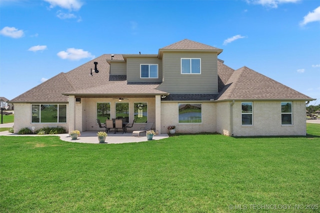 8209 N 150th Ave E, Owasso, OK 74055 - rear view of house with ceiling fan, a shingled roof, a patio area, a yard, and brick siding