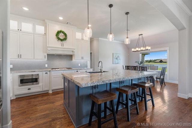 8209 N 150th Ave E, Owasso, OK 74055 - kitchen featuring a sink, tasteful backsplash, white cabinets, an island with sink, and dark wood finished floors