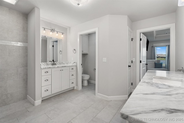 8209 N 150th Ave E, Owasso, OK 74055 - bathroom featuring vanity, toilet, baseboards, and tile patterned floors