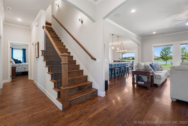 8209 N 150th Ave E, Owasso, OK 74055 - staircase featuring arched walkways, crown molding, wood finished floors, a ceiling fan, and baseboards