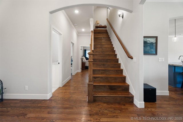 8209 N 150th Ave E, Owasso, OK 74055 - stairs featuring crown molding, baseboards, recessed lighting, wood finished floors, and arched walkways