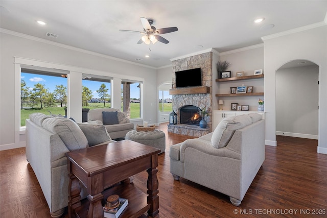 8209 N 150th Ave E, Owasso, OK 74055 - living room with a ceiling fan, arched walkways, baseboards, a stone fireplace, and ornamental molding