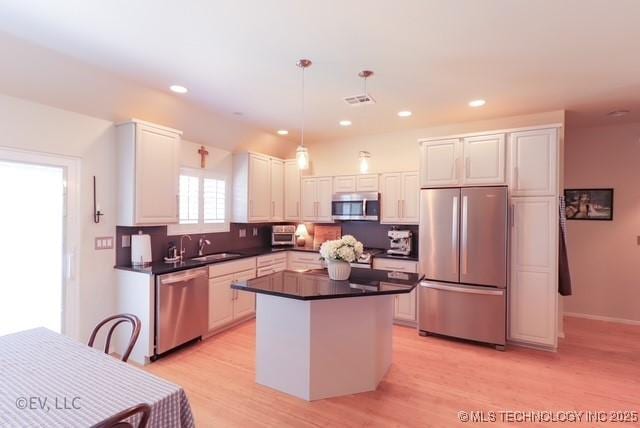14538 S Kendalwood Blvd E, Glenpool, OK 74033 - kitchen featuring appliances with stainless steel finishes, dark countertops, light wood-style flooring, white cabinets, and recessed lighting