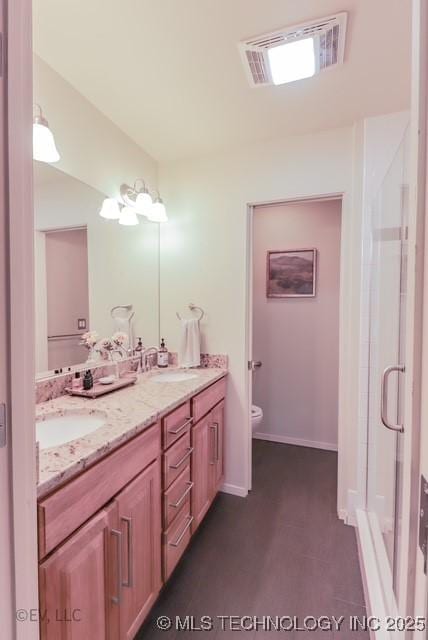 14538 S Kendalwood Blvd E, Glenpool, OK 74033 - bathroom with double vanity, toilet, and a stall shower