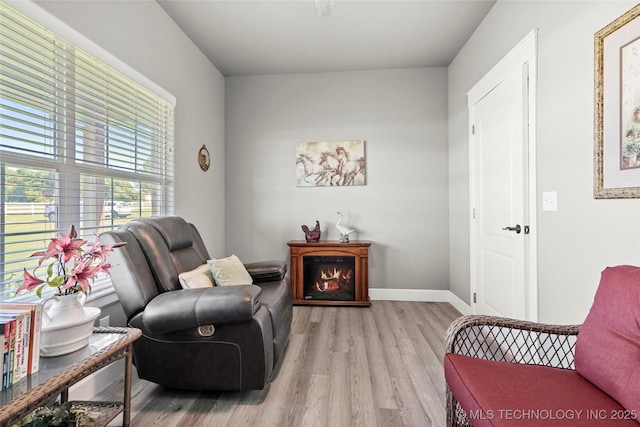 8323 S 2nd W, Muskogee, OK 74401 - sitting room featuring light wood-style flooring, baseboards, and a lit fireplace