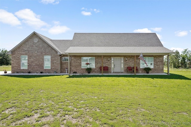 8315 S 2nd W, Muskogee, OK 74401 - view of front of house with a front lawn, roof with shingles, brick siding, and a patio area