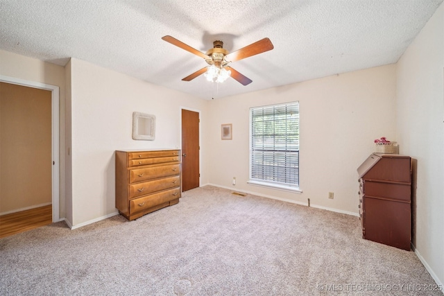 13200 E 130th St S, Broken Arrow, OK 74011 - unfurnished bedroom with carpet flooring, a textured ceiling, baseboards, and ceiling fan
