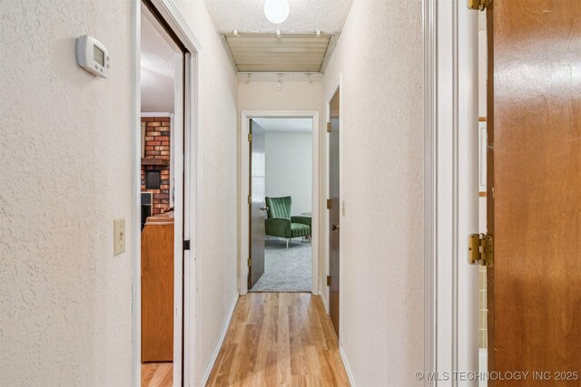 13200 E 130th St S, Broken Arrow, OK 74011 - hall with a textured wall, wood finished floors, and a textured ceiling