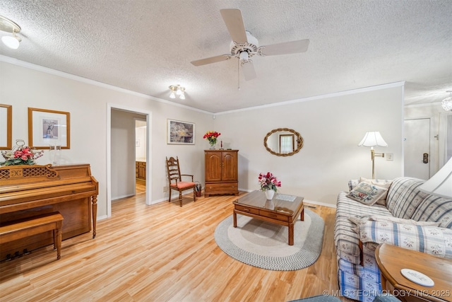 13200 E 130th St S, Broken Arrow, OK 74011 - living area with crown molding, a textured ceiling, light wood finished floors, ceiling fan, and baseboards
