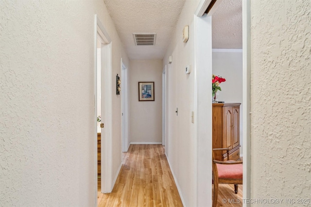 13200 E 130th St S, Broken Arrow, OK 74011 - corridor featuring a textured wall, light wood-style floors, a textured ceiling, and baseboards
