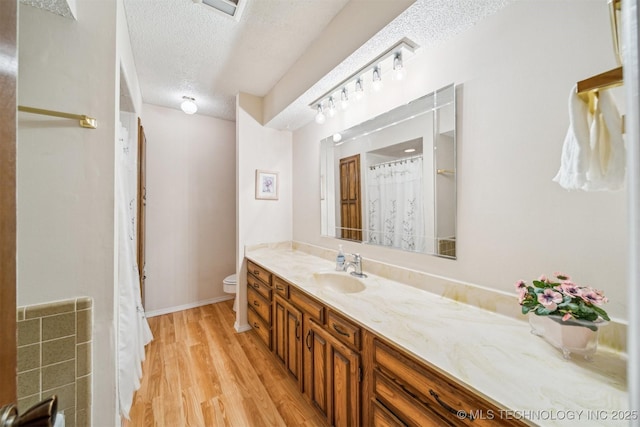 13200 E 130th St S, Broken Arrow, OK 74011 - full bathroom featuring vanity, toilet, wood finished floors, a textured ceiling, and a shower with shower curtain