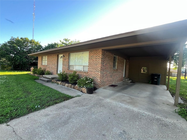 417 S 16th Ave, Durant, OK 74701 - single story home with a front lawn, driveway, brick siding, and a carport