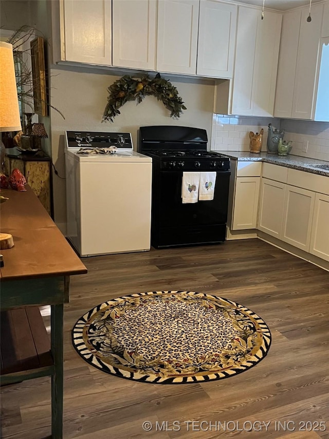 417 S 16th Ave, Durant, OK 74701 - kitchen with washer / clothes dryer, black range with gas cooktop, dark wood-type flooring, and tasteful backsplash