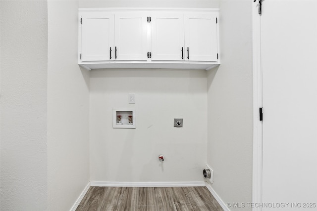 401 E 25th St, Okmulgee, OK 74447 - washroom with hookup for a washing machine, wood finished floors, baseboards, cabinet space, and hookup for a gas dryer