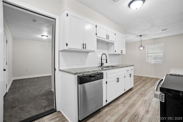 401 E 25th St, Okmulgee, OK 74447 - kitchen with stainless steel dishwasher, a sink, light stone countertops, white cabinets, and tasteful backsplash