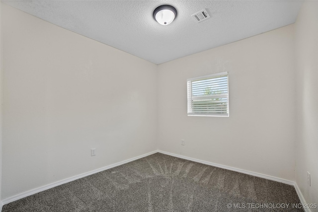 401 E 25th St, Okmulgee, OK 74447 - spare room featuring dark carpet, a textured ceiling, and baseboards